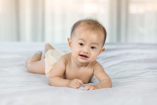 portrait of baby on a bed in bedroom at home