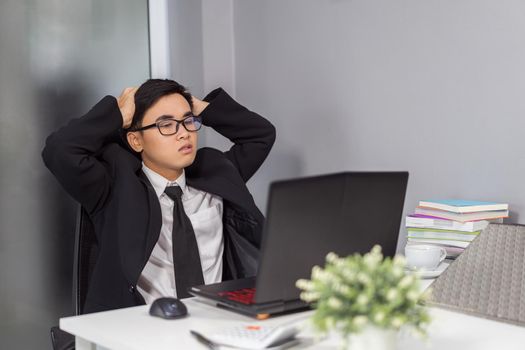 young business man working problem using laptop