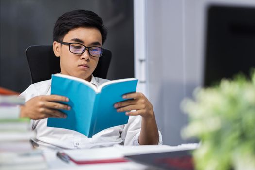 young student reading a book