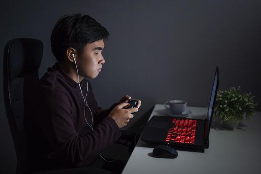 young man using joystick to playing games