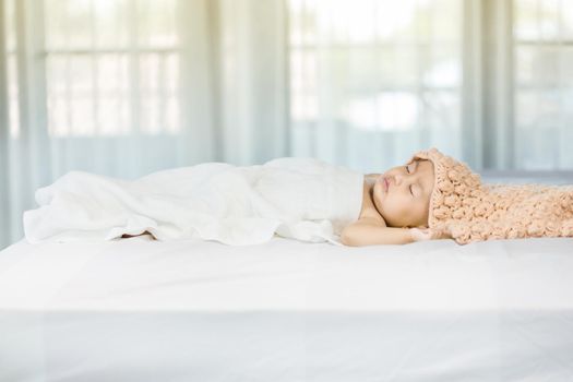 Baby sleeping on bed in the bedroom at home