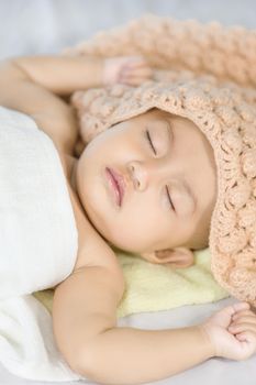 Baby sleeping on bed in the bedroom at home