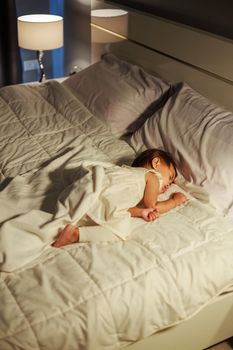 baby sleeping on bed in bedroom at home