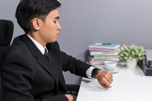 young business man checking time on smart watch 