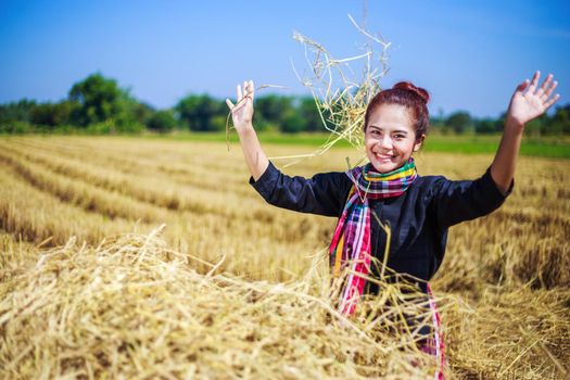 farmer woman relaxing with the straw in field, Thailand