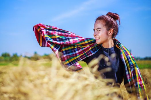 beautiful farmer woman with the straw in field, Thailand