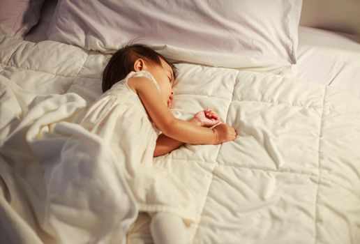 baby sleeping on bed in bedroom at home