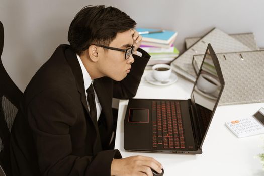 young business man working problem using laptop