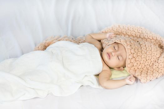 Baby sleeping on bed in the bedroom at home