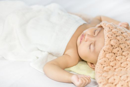 Baby sleeping on bed in the bedroom at home