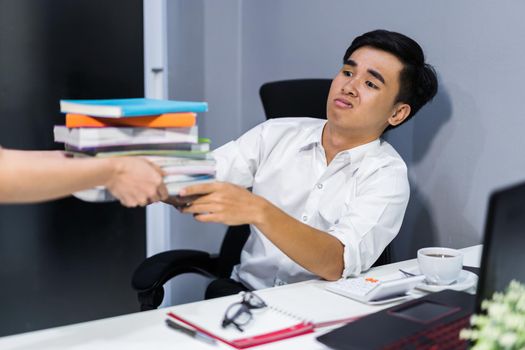 hand giving a book to bored student