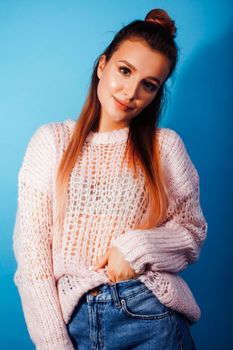 young pretty modern hipster girl posing emotional happy on blue background, lifestyle people concept close up