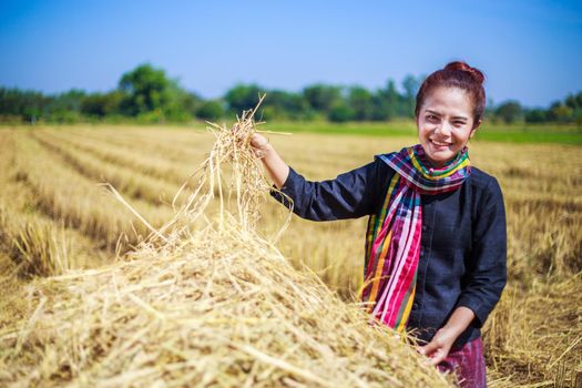 farmer woman relaxing with the straw in field, Thailand