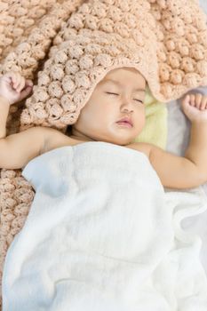 Baby sleeping on bed in the bedroom at home