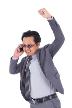 happy businessman talking on smartphone with arm raised isolated on a white background