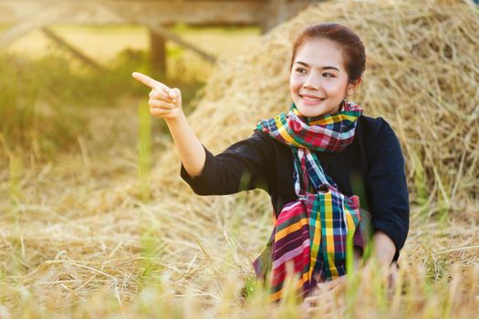 farmer woman resting with the straw in field, Thailand