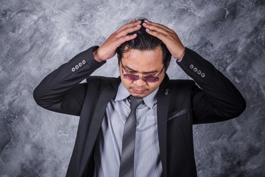 young business man in suit with headache and problems