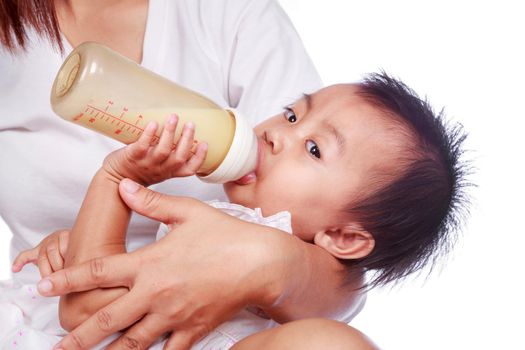 Mother feeding baby daughter isolated on a white background