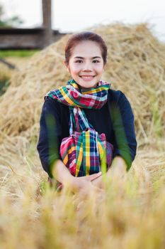 farmer woman resting with the straw in field, Thailand