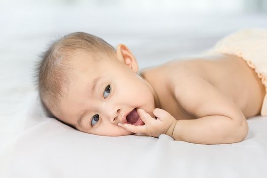 portrait of baby on a bed in bedroom at home