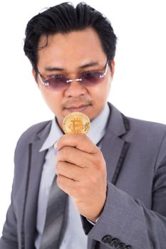 man holding golden bitcoin in hand isolated on a white background