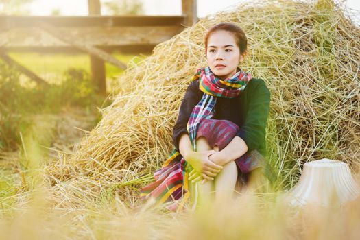 farmer woman resting with the straw in field, Thailand