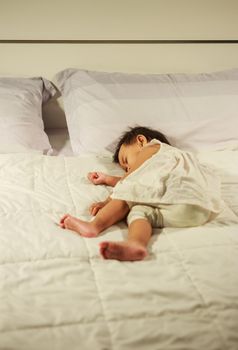 baby sleeping on bed in bedroom at home