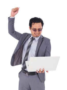 winner business man holding laptop with arms raised isolated on a white background