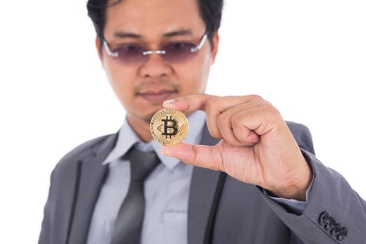 man holding golden bitcoin in hand isolated on a white background