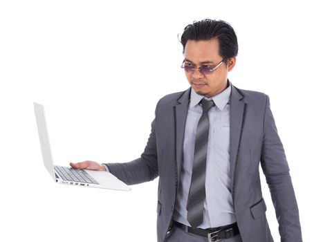 business man holding laptop isolated on a white background