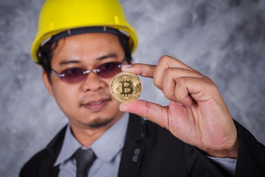 bitcoin in hand of engineer with suit