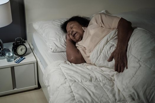 senior woman sleeping in a bed