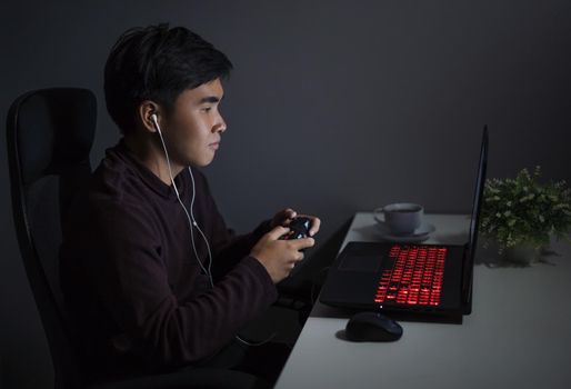 happy young man using joystick to playing games