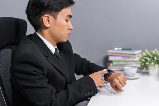 young business man checking time on smart watch 