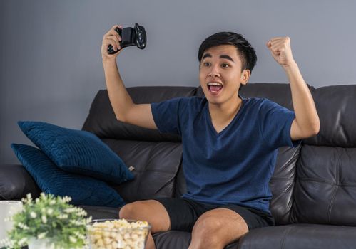 young man playing video games and wins