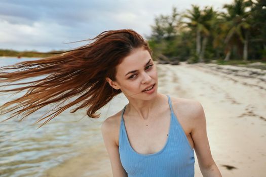 woman in blue swimsuit on the beach island lifestyle. High quality photo