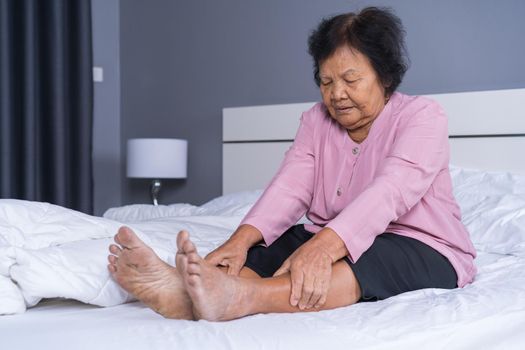 senior woman with leg pain in a bed