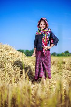 beautiful farmer woman with the straw in field, Thailand