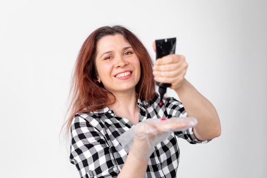 Young woman dyes her hair at home. Bright hair coloring