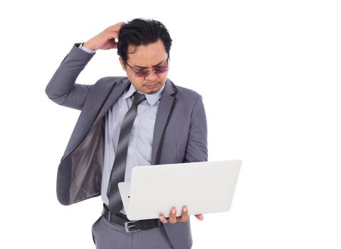 business man with headache and having problems on laptop isolated on a white background