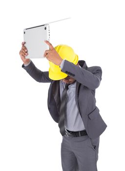 very angry engineer is throwing away his laptop isolated on a white background