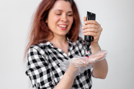 Young woman dyes her hair at home. Bright hair coloring