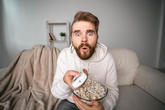 Portrait of guy watching TV series online. Online cinema and video streaming service