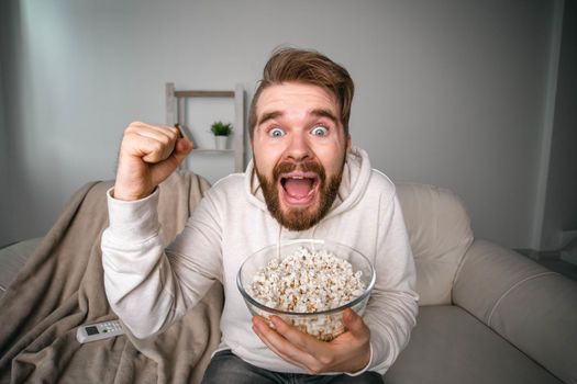Portrait of guy watching TV series online. Online cinema and video streaming service