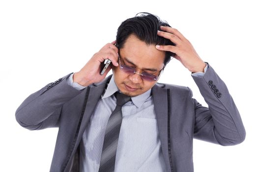 business man receiving bad news on the cell phone isolated on a white background