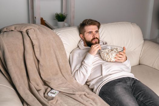 Portrait of guy watching TV series online. Online cinema and video streaming service
