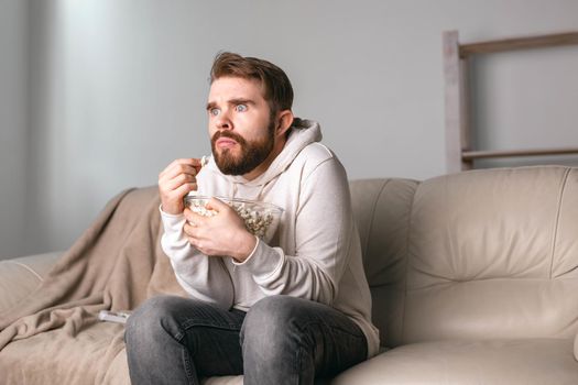 Portrait of guy watching TV series online. Online cinema and video streaming service