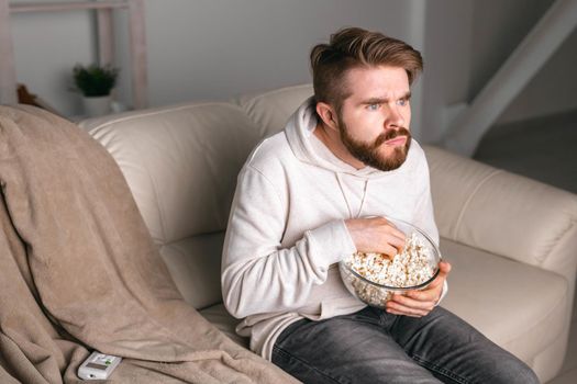 Portrait of guy watching TV series online. Online cinema and video streaming service