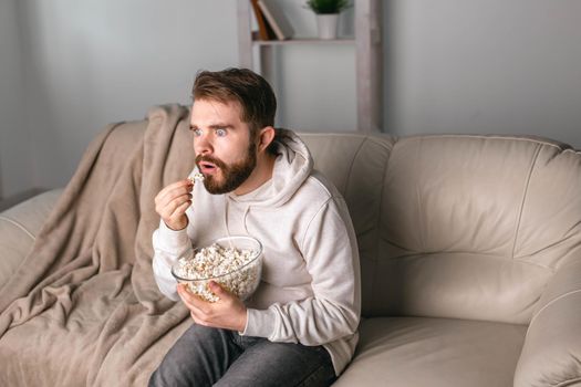 Portrait of guy watching TV series online. Online cinema and video streaming service