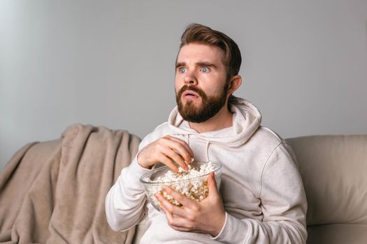 Portrait of guy watching TV series online. Online cinema and video streaming service